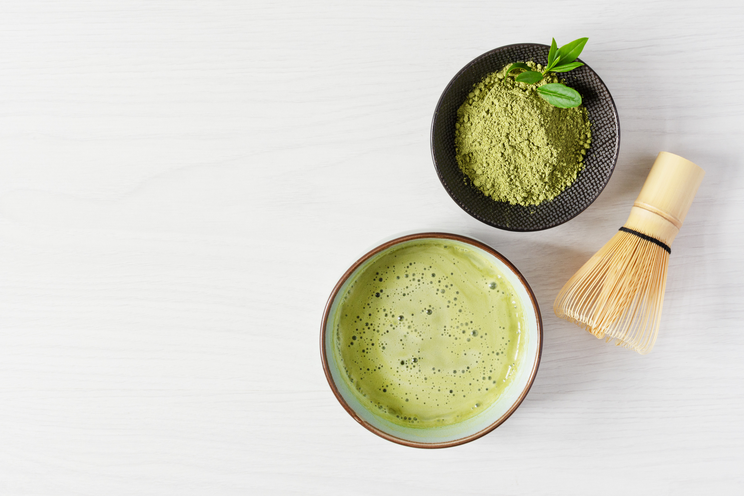 Organic green matcha tea. Matcha powder and matcha tea drink in a bowl.